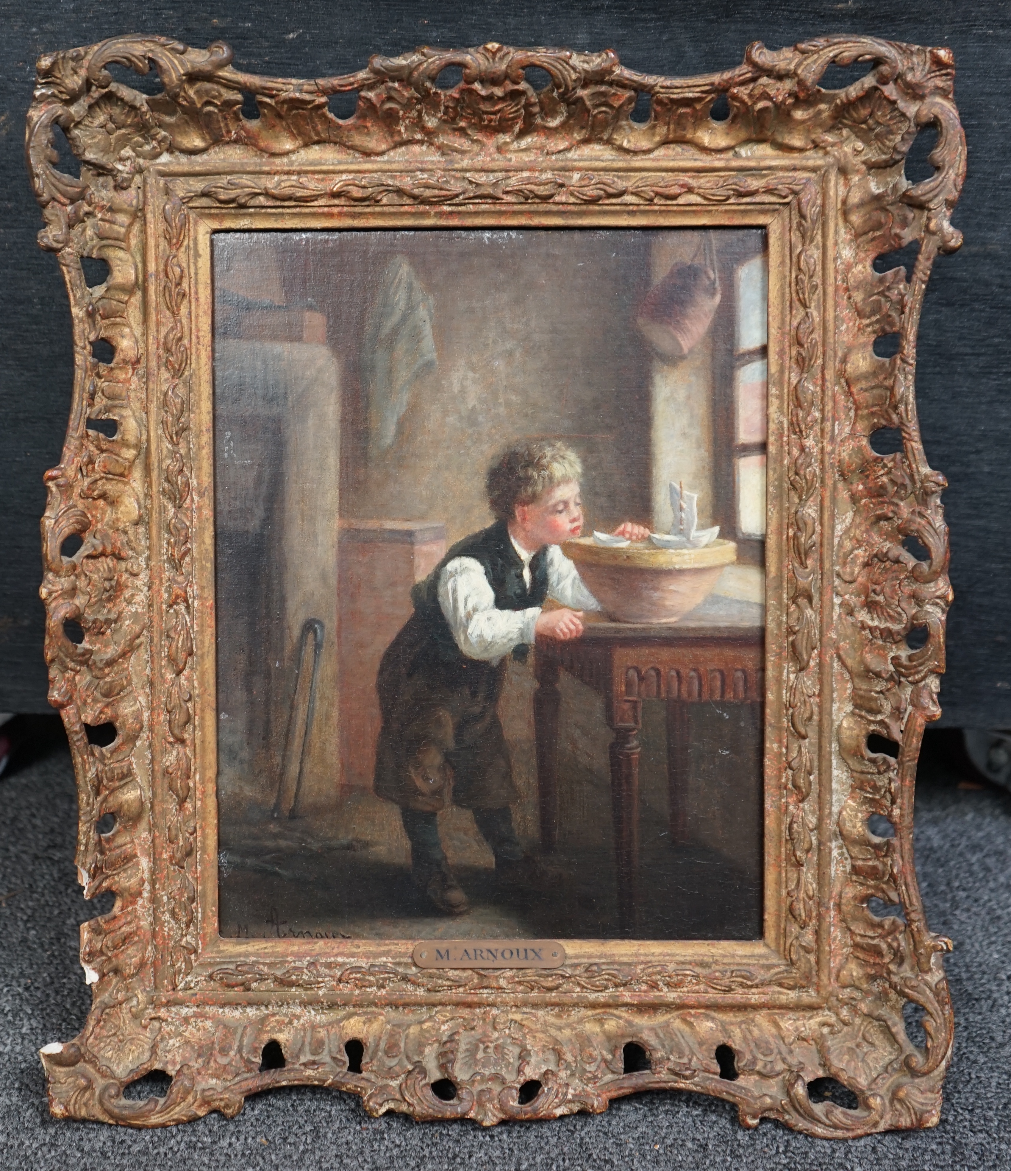 Michel Arnoux (French, 1833-1877), Interior with boy playing with model sailing boats, oil on mahogany panel, 24 x 18cm